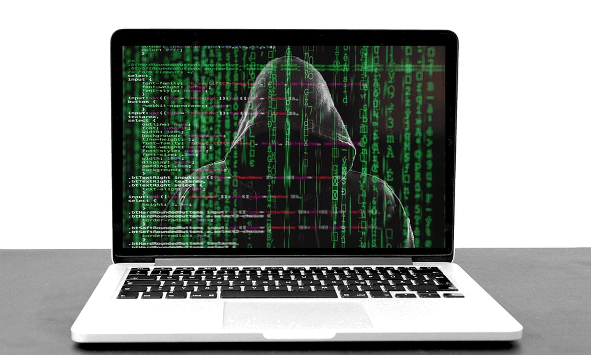 Opened Laptop showing a hooded guys with green codes as if portraying Malware attack