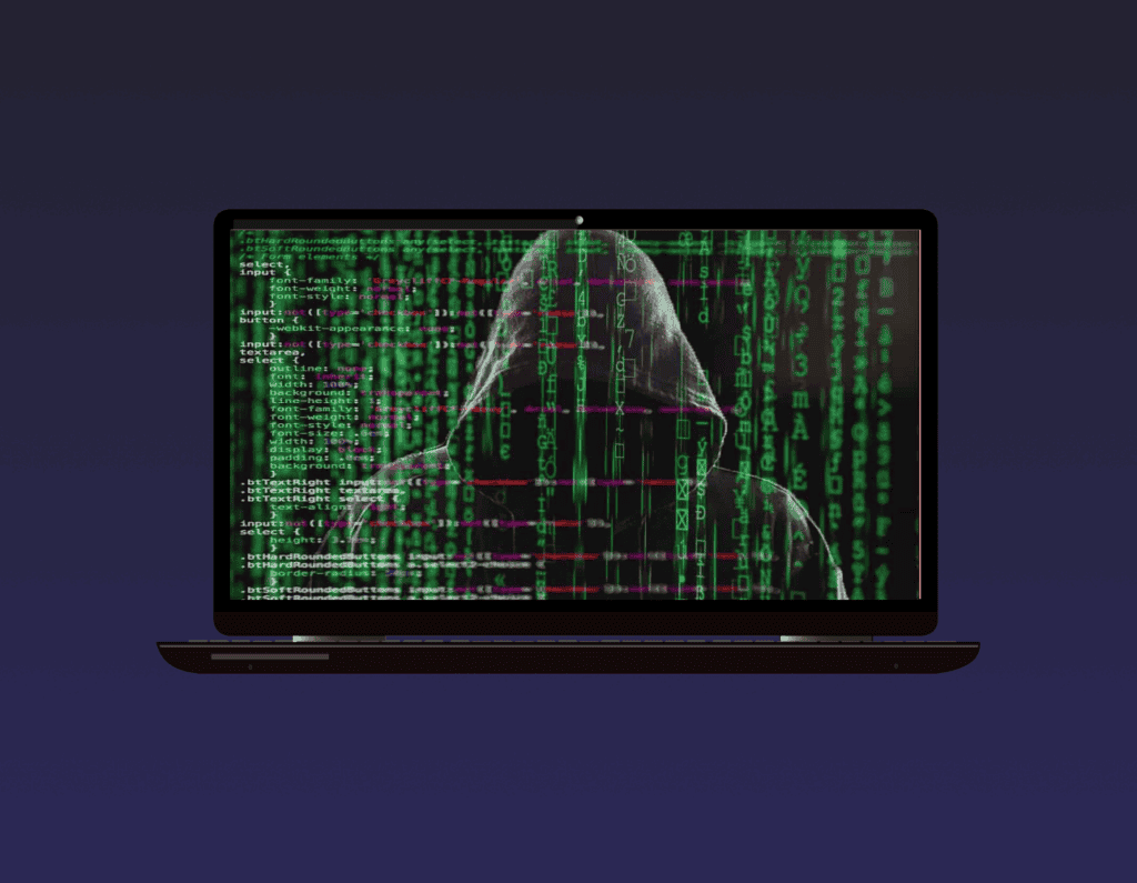 opened laptop, showing a hooded man surrounded by letters in green and a short strip of code on the screen.