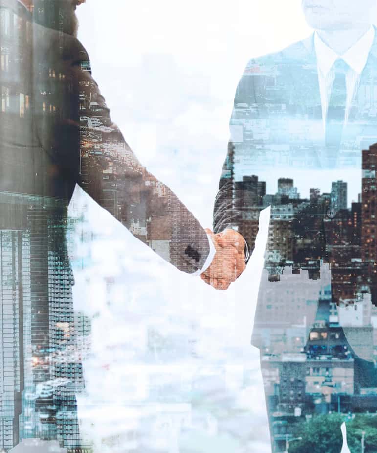 two business man doing a handshake with double exposure of image of buildings