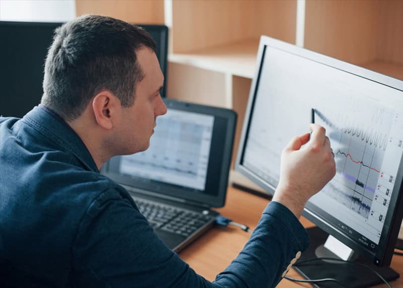 Guy looking at a monitor focused like examining something