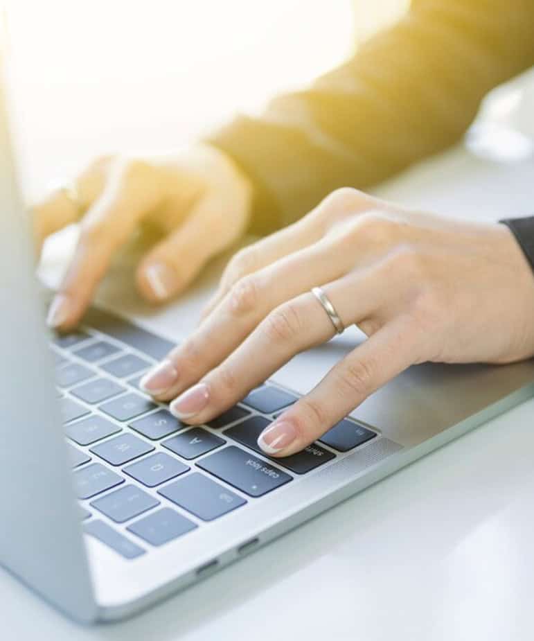 hands on the keyboard of a laptop