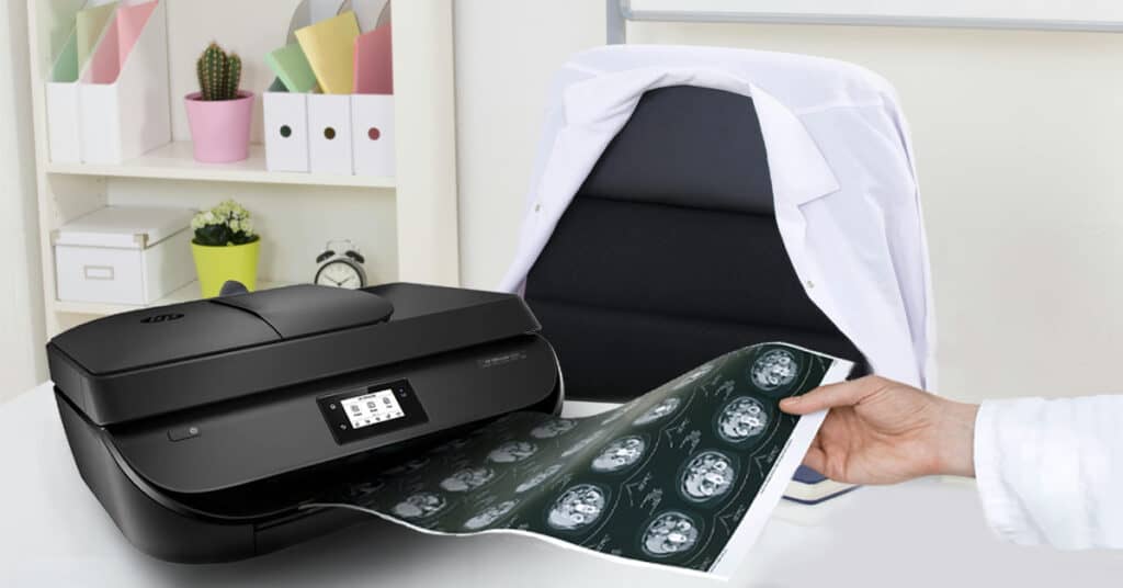 Doctor holding a printed xray result using a paper and regular office printer with the help of DicomJet by neologica